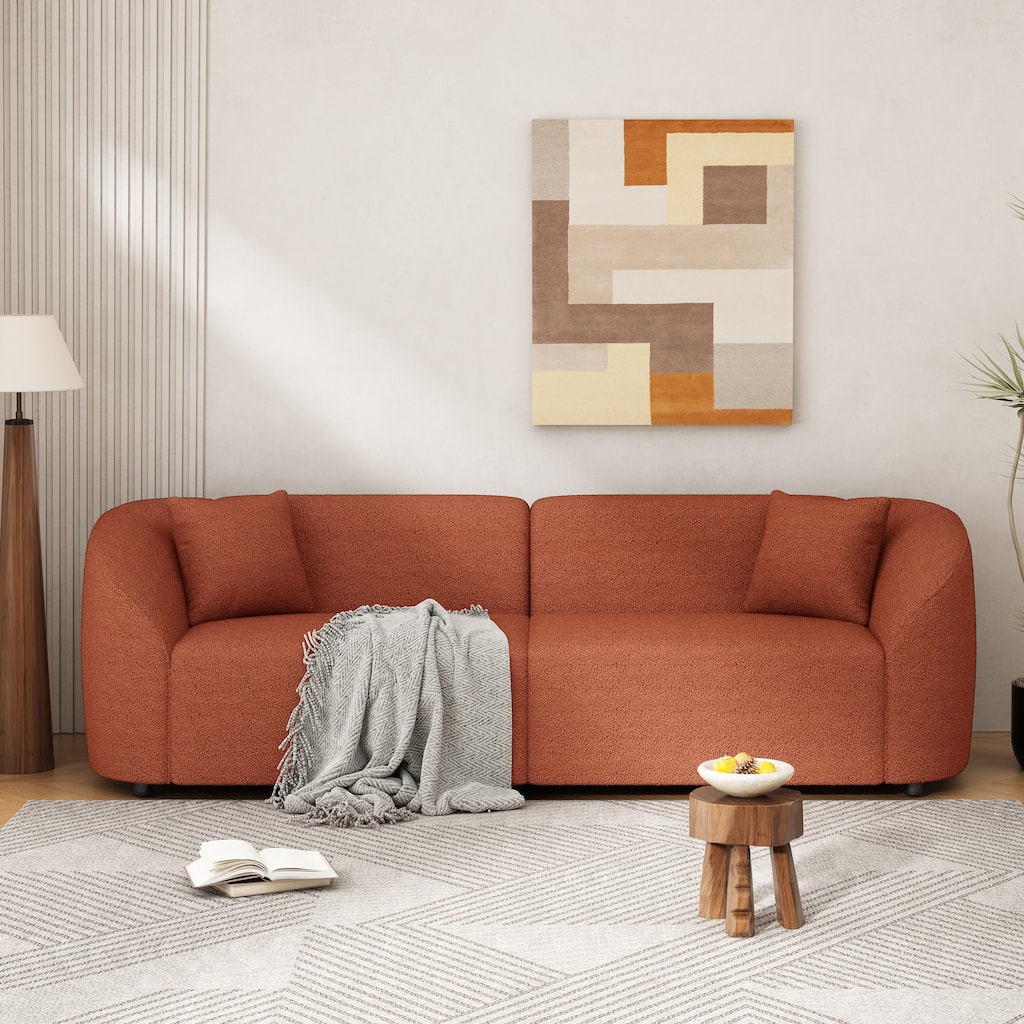Curved Contemporary Sofa In Orange: Plush Seating, Streamlined Design, And Durable Frame