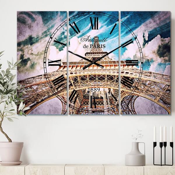 slide 2 of 6, Designart 'Paris Eiffel TowerUnder Blue Sky' Cottage 3 Panels Oversized Wall CLock - 36 in. wide x 28 in. high - 3 panels