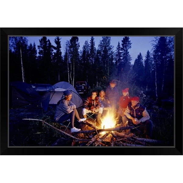 "Group of people sitting by campfire" Black Framed Print