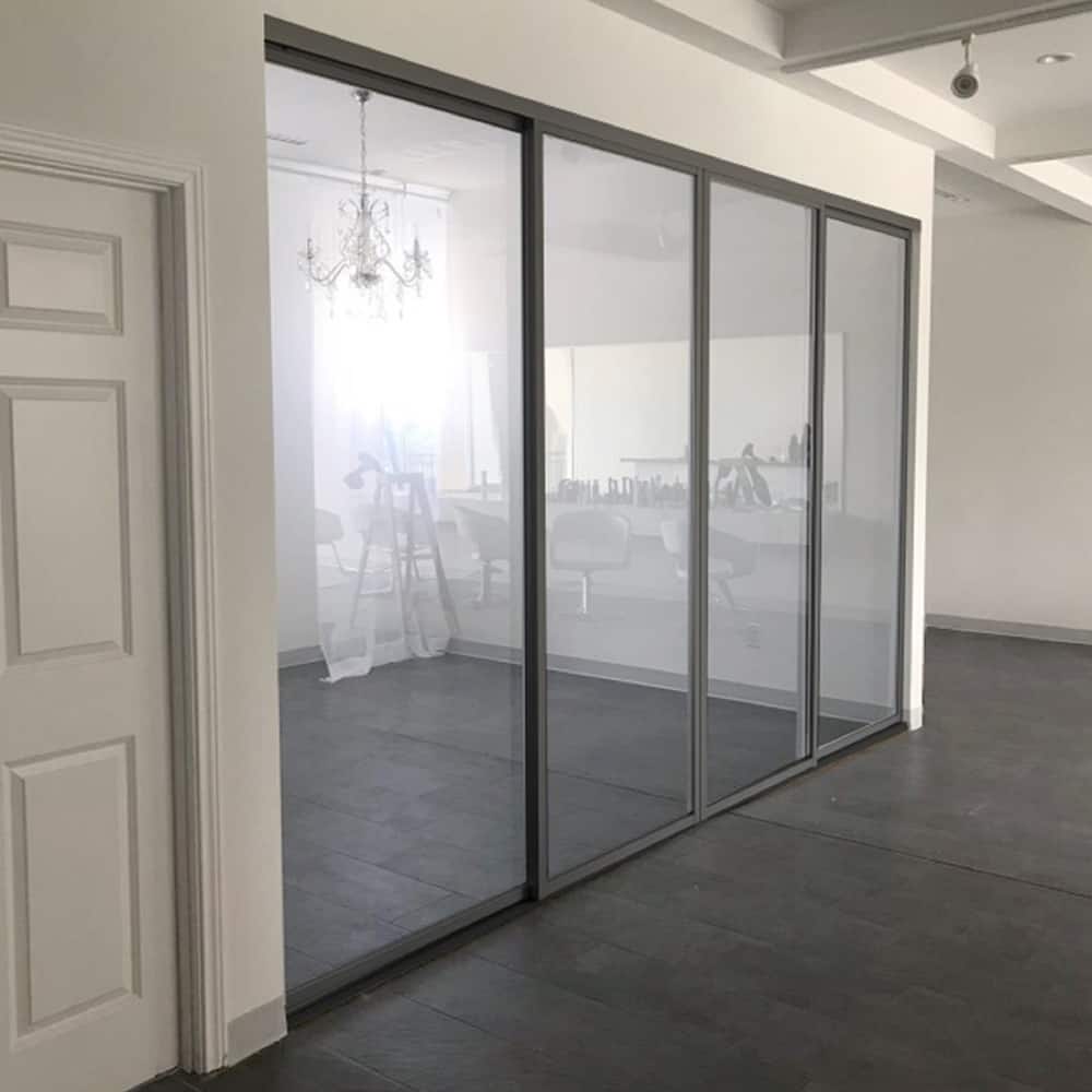 THE SLIDING DOOR COMPANY 4 Panel, sliding room divider, Clear Glass and Aluminum Frame on double track.