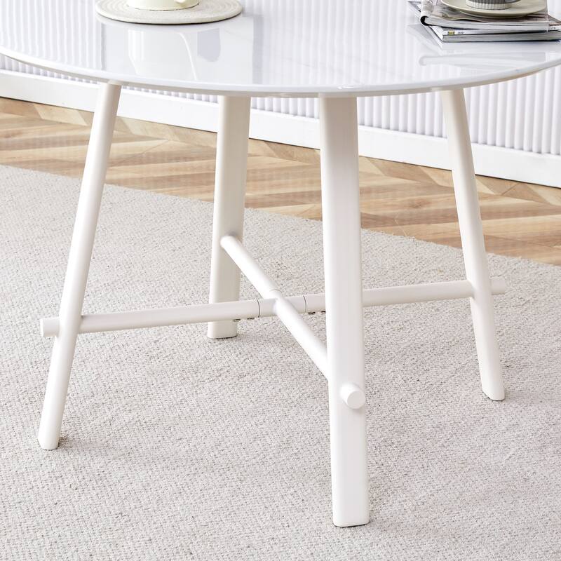 A Modern Minimalist Circular Dining Table With A 42 Inch Diameter White Patterned Tabletop And White Metal Legs