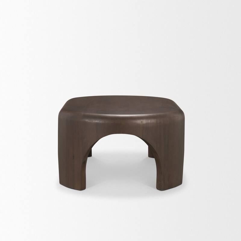 The Shima Coffee Table is a smooth, dark matte brown oval coffee table with curved edges and arched cut out legs.