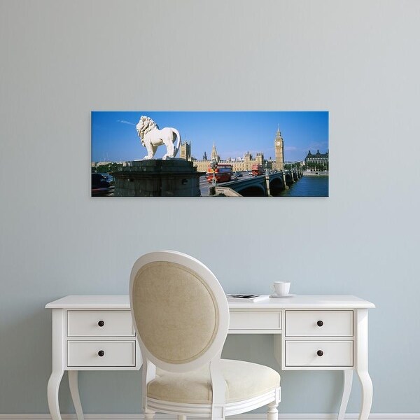 Easy Art Prints Panoramic Image 'Lion statue at an arched bridge, Houses Of Parliament, London, England' Canvas Art