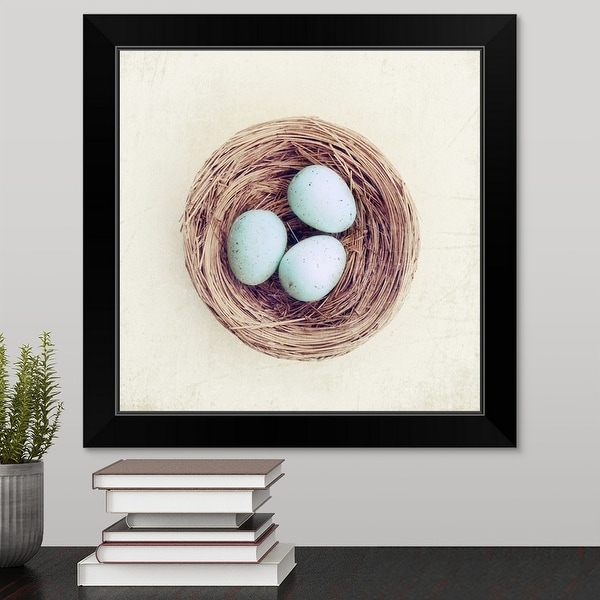 "Bird nest with blue baby robins eggs against neutral textured background." Black Framed Print