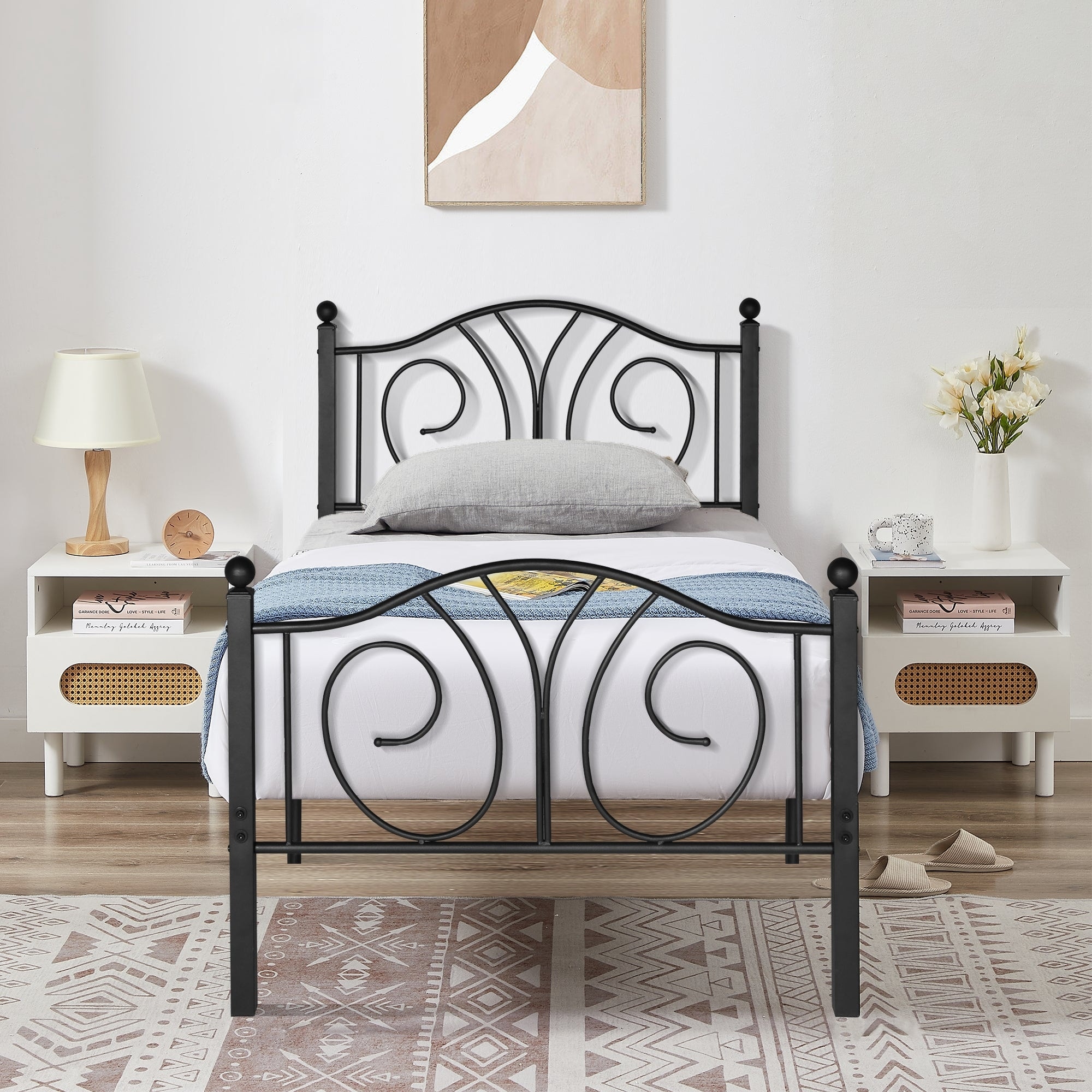 A black metal bed frame with decorative swirl patterns in a minimalist apartment bedroom