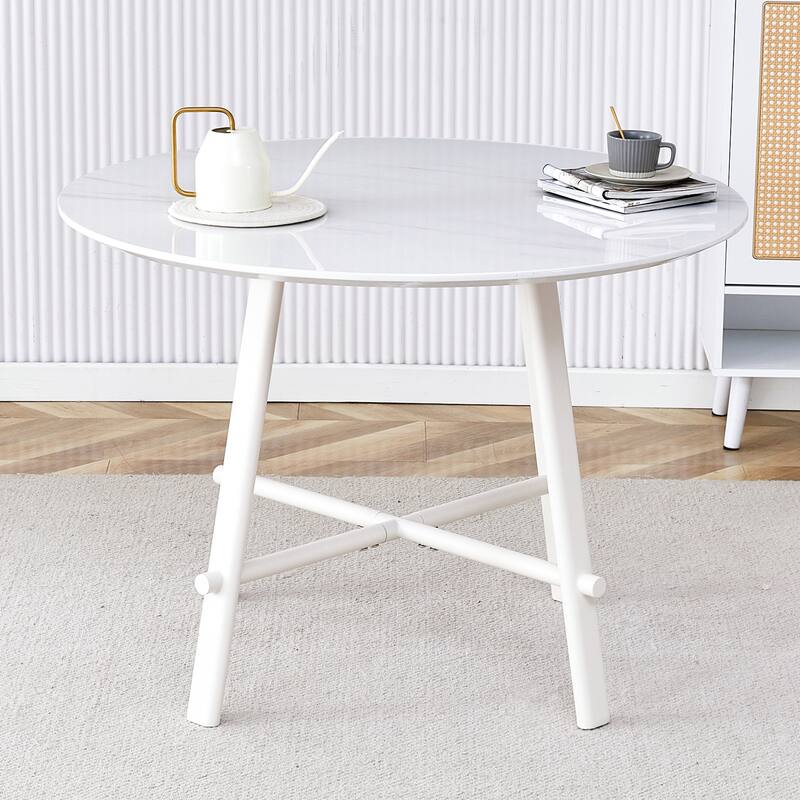 A Modern Minimalist Circular Dining Table With A 42 Inch Diameter White Patterned Tabletop And White Metal Legs