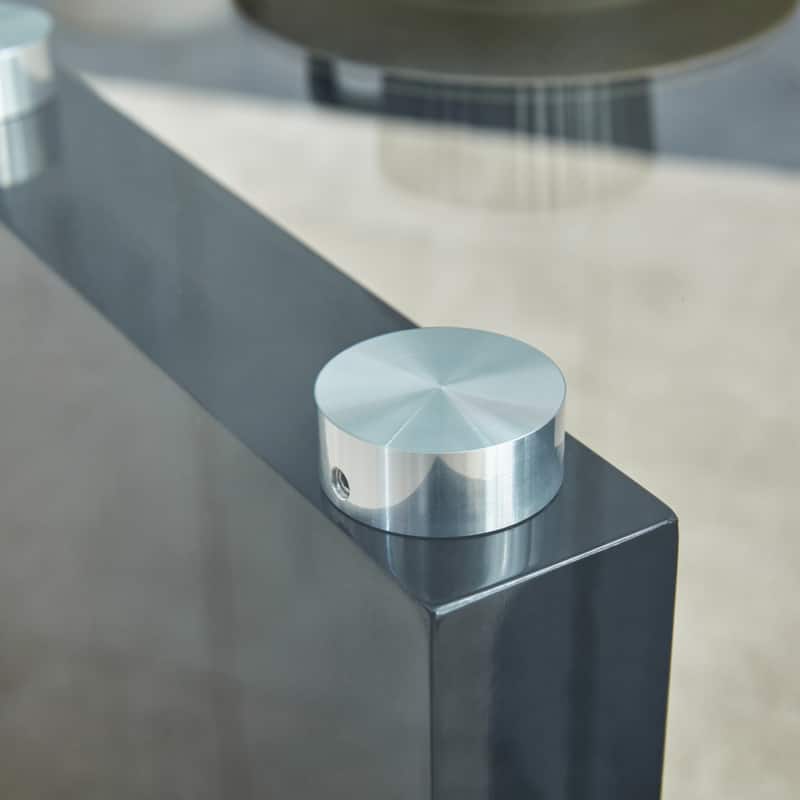 A rectangular modern and fashionable coffee table with tempered glass tabletop and black MDF legs