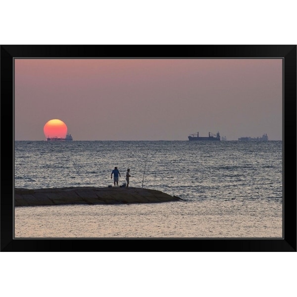 "Men fishing at Seawall Boulevard pier, with ships on their way to port, at sunrise" Black Framed Print
