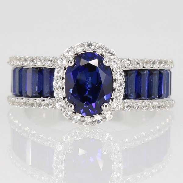 Oval & Baguette-cut Created Blue and White Sapphire Halo Engagement Ring in Sterling Silver by Miadora. Opens flyout.