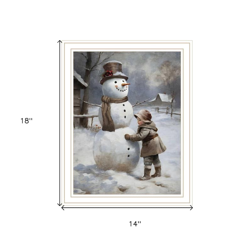 HomeRoots Boy Building A Snowman White Framed Wall Art