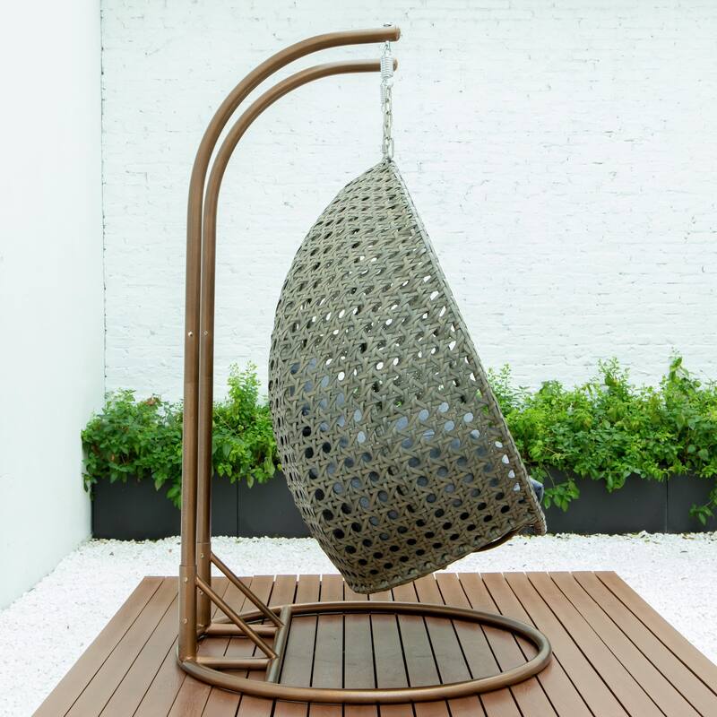 LeisureMod 2-Person Hanging Egg Swing Chair with Metal Stand - Handcrafted Beige Wicker, Patio Hammock Lounger with Cushions