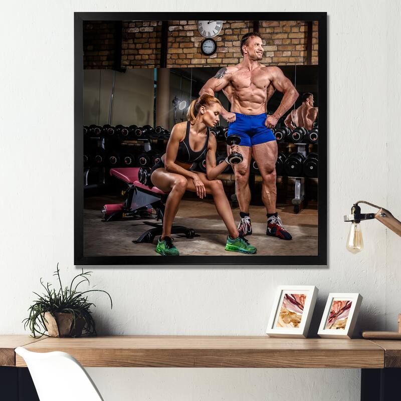 Designart "Sports Couple Is Working Out Gym" Aerobic & Bodybuilding Framed Canvas Prints - 36 in. wide x 36 in. high - Black