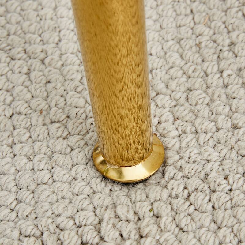 A glass tabletop with a diameter of 40 inches and a modern minimalist circular dining table with gold plated metal legs.