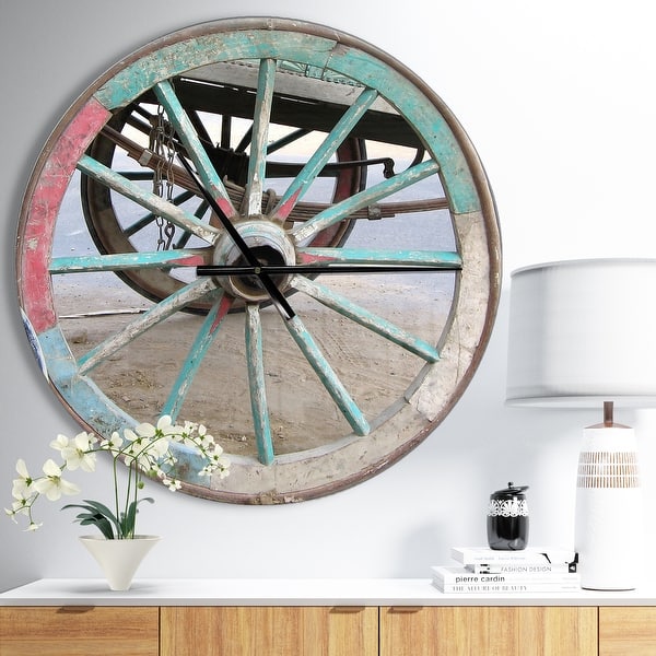 slide 2 of 9, Designart 'Turquoise Painted Cottage Wagon Wheel Clock' Oversized Farmhouse Wall CLock 23 in. wide x 23 in. high