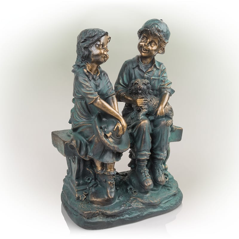 Girl and Boy Sitting on Bench with Puppy Statue