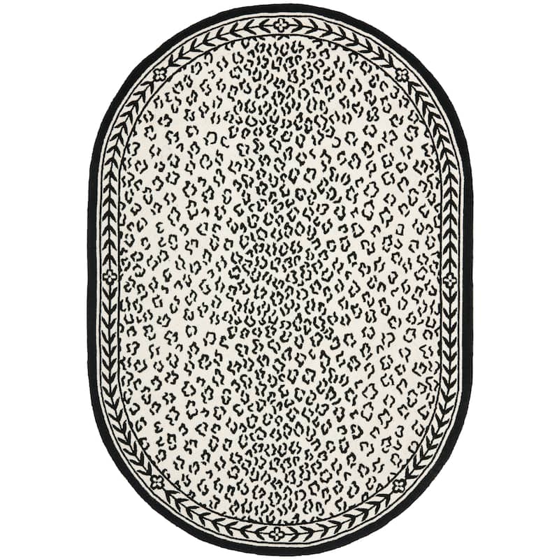 SAFAVIEH Handmade Chelsea Solar Garden Leopard French Country Wool Rug - 7'6" x 9'6" Oval - White/Black