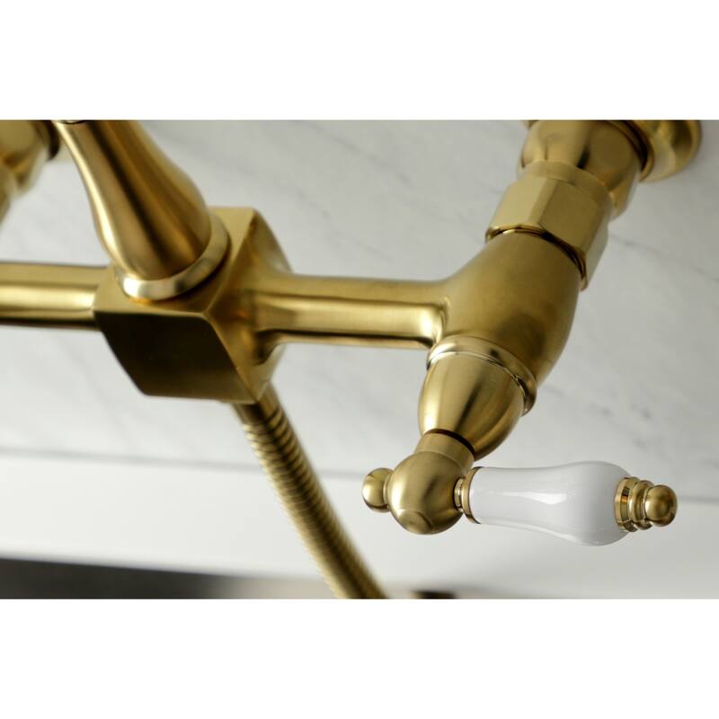 Kingston Brass Heritage Wall Mount Bridge Kitchen Faucet with Brass Sprayer