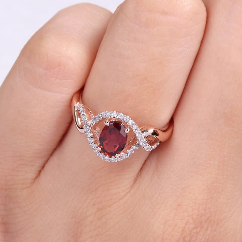 Miadora 10k Rose Gold Garnet and 1/6ct TDW Diamond Halo Infinity Ring