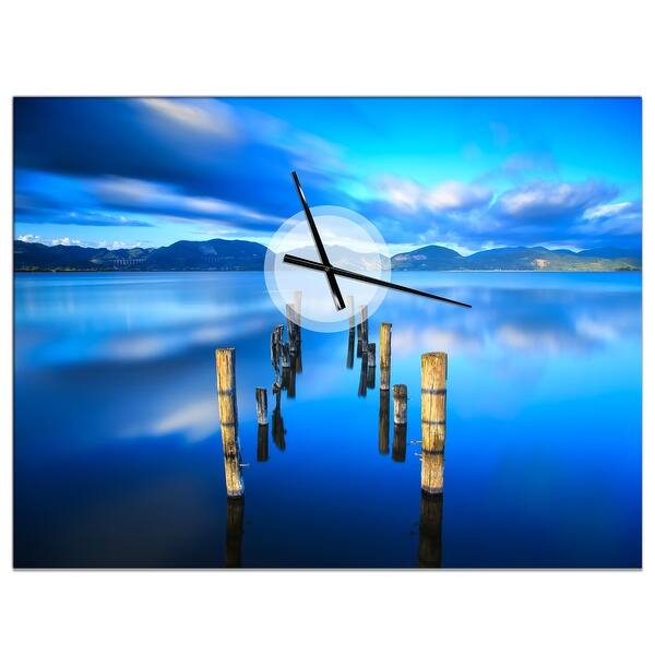 slide 2 of 7, Designart 'Wooden Pier Remains in Blue Sea' Oversized Coastal Wall CLock