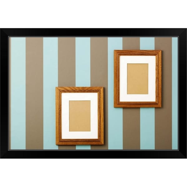 "Striped wallpaper with empty wood frames on walls" Black Framed Print