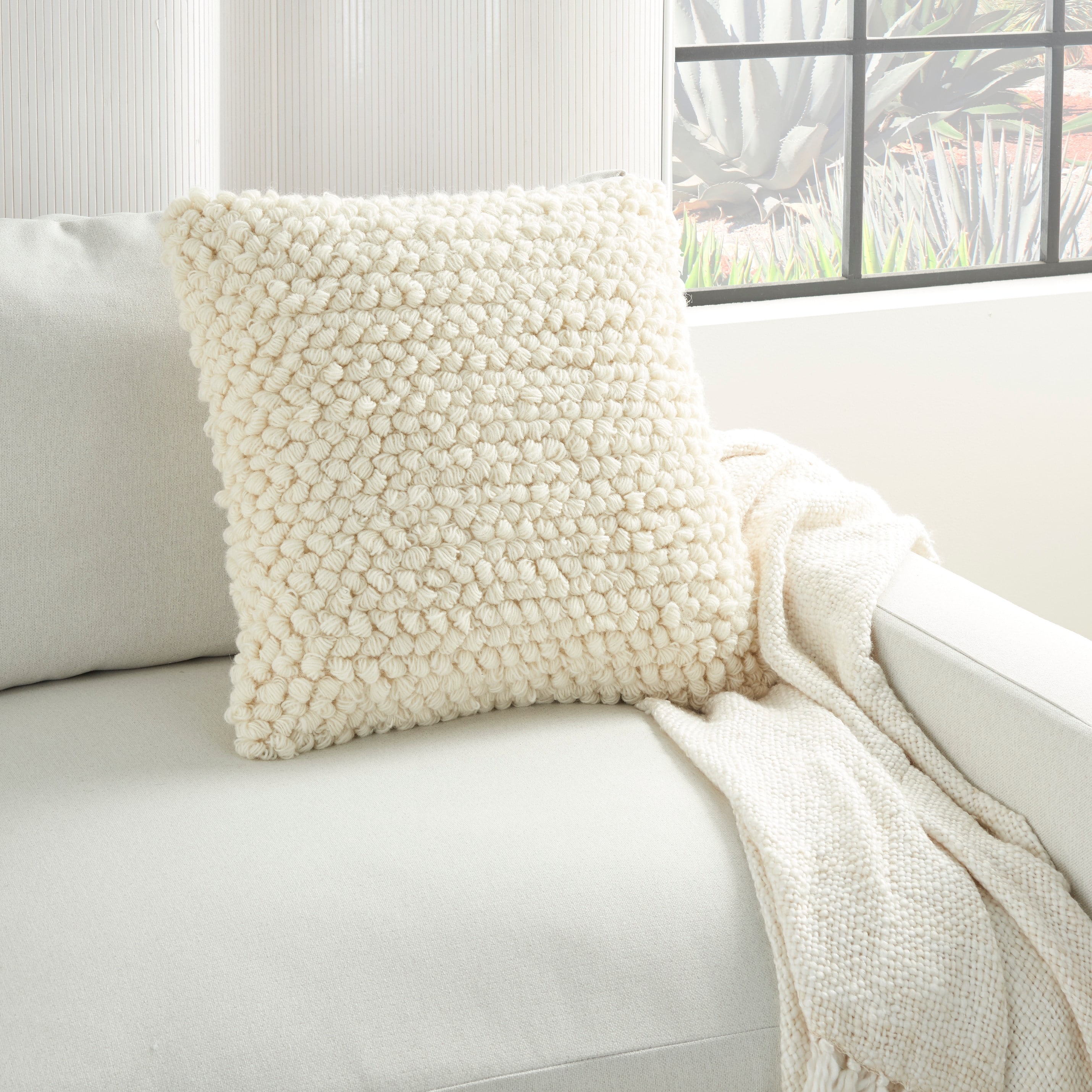 https://ak1.ostkcdn.com/images/products/is/images/direct/48114a097a40b533e97e31ce6fb2e6c5bd2d2fc5/The-Curated-Nomad-Cantera-Loops-Ivory-Throw-Pillow-%2820-inch-x-20-inch%29.jpg