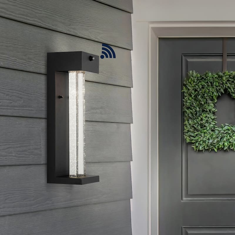 Horizone 5.13" 1-Light Modern Iron/Seeded Glass with Dusk-to-Dawn Sensor Integrated LED Outdoor Sconce, Black by JONATHAN Y