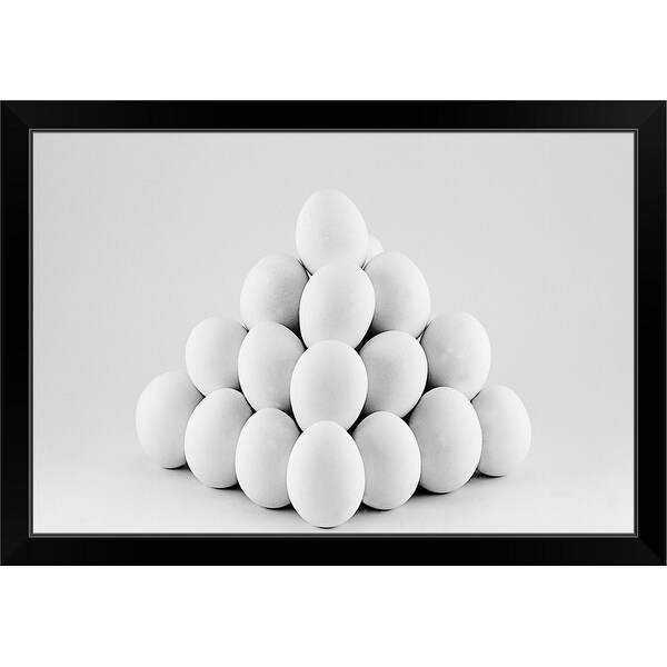 "Pyramid of white eggs on bright gray background." Black Framed Print