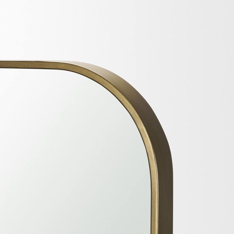 Timon is a square mirror with an arched brushed gold metal frame. - 36.0L x 1.8W x 34.3H
