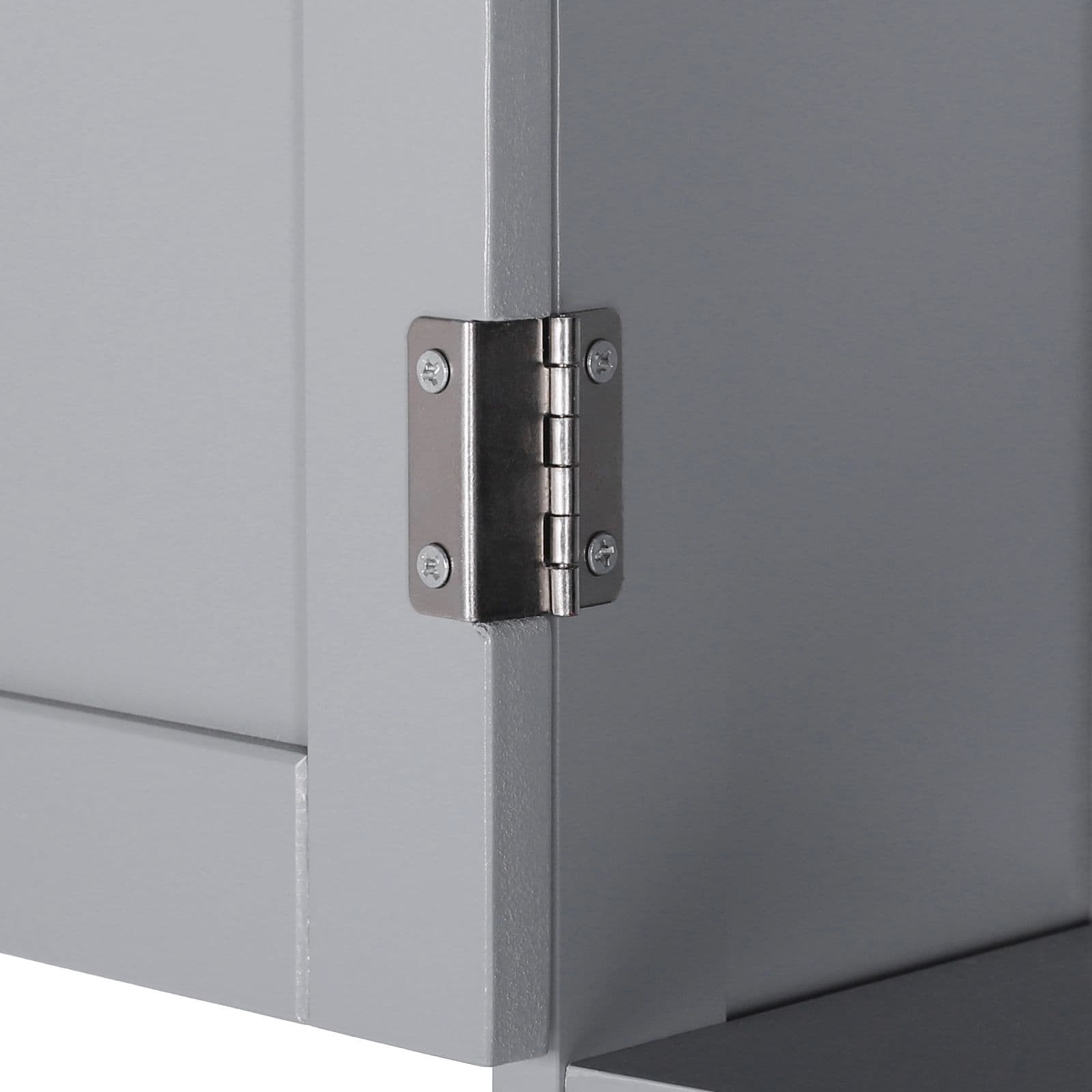 Close-up of a metal door hinge on the bathroom storage cabinet.