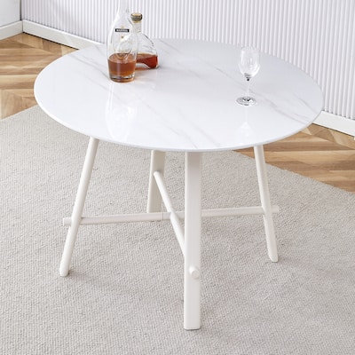 A Modern Minimalist Circular Dining Table With A 42 Inch Diameter White Patterned Tabletop And White Metal Legs