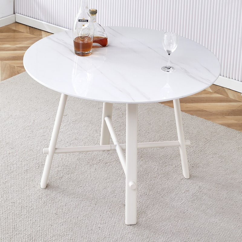 A modern minimalist circular dining table with a 42 inch diameter white patterned tabletop and white metal legs - White