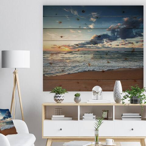 Designart 'Sunrise and Glowing Waves in Ocean' Seascape Print on Natural Pine Wood - Blue