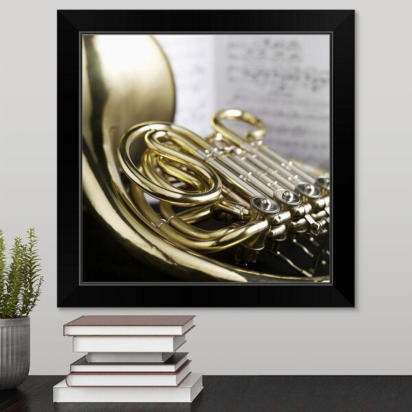 "French horn in front of sheet music" Black Framed Print