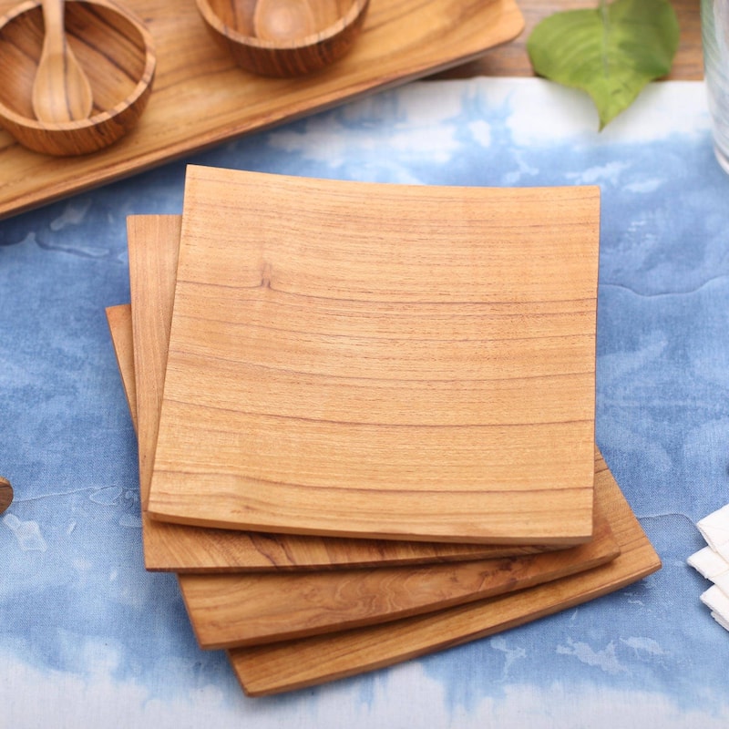 NOVICA Teakwood plates, 'Fine Meal' (set of 4)