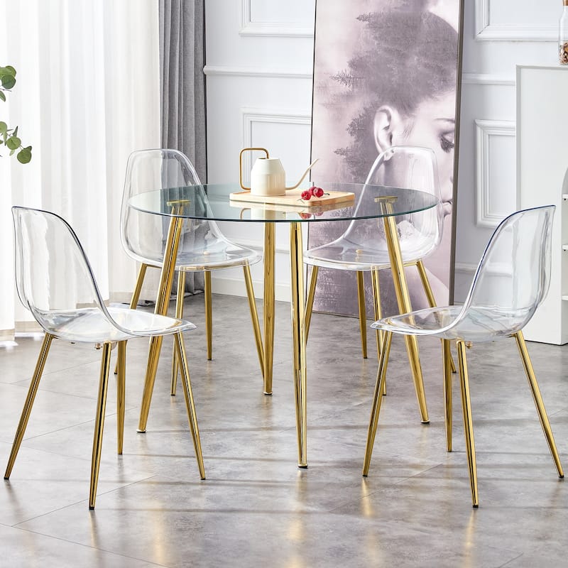 A glass tabletop with a diameter of 40 inches and a modern minimalist circular dining table with gold plated metal legs