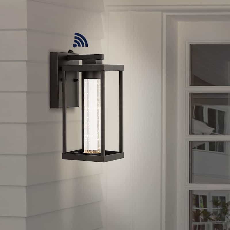 Justina 4.75" 1-Light Industrial Iron/Seeded Glass with Dusk-to-Dawn Sensor Integrated LED Outdoor Sconce, Black by JONATHAN Y