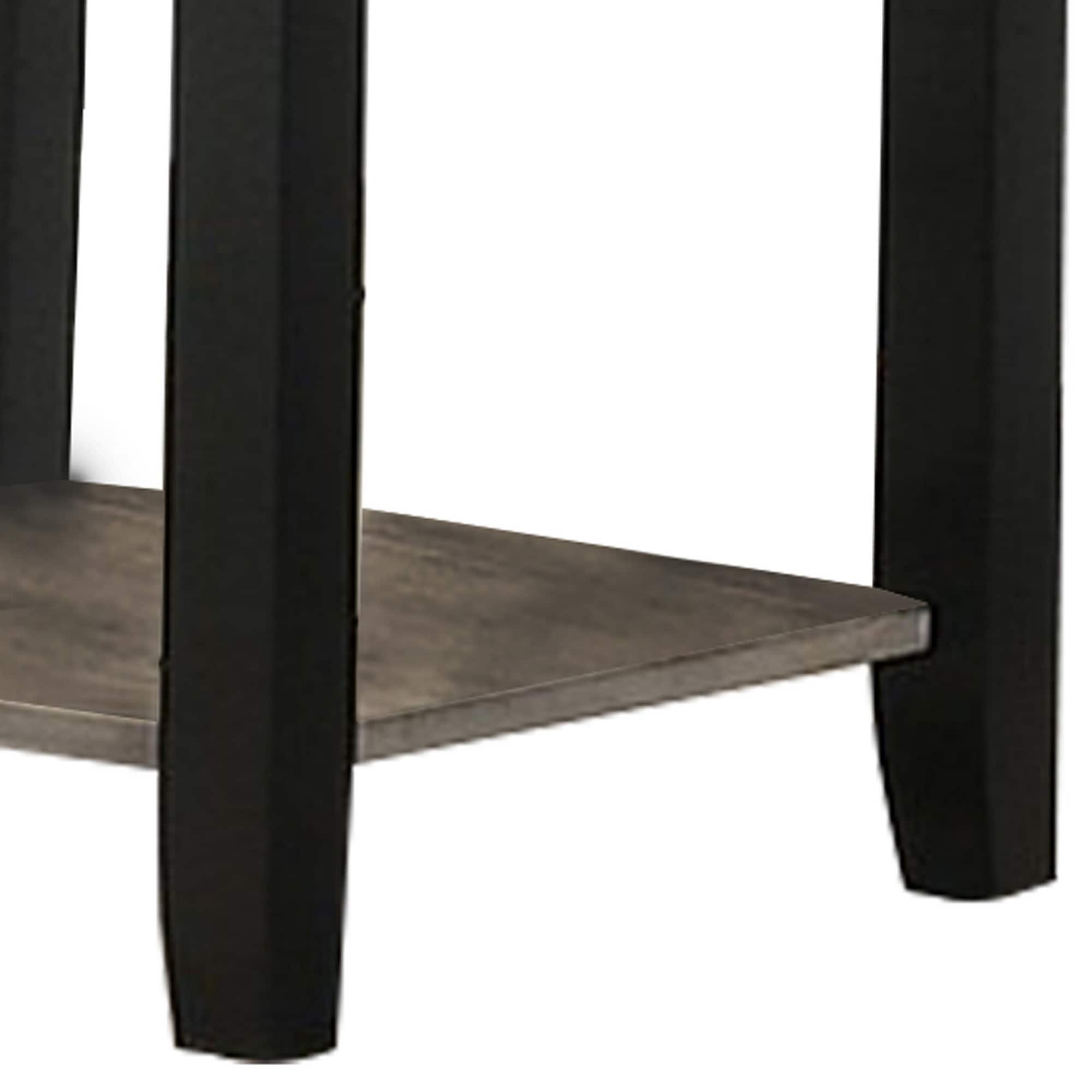 Close-up view of the black frame and wood shelf of an end table.