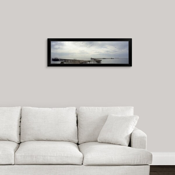 "Piers accessing oil platforms in ocean" Black Framed Print