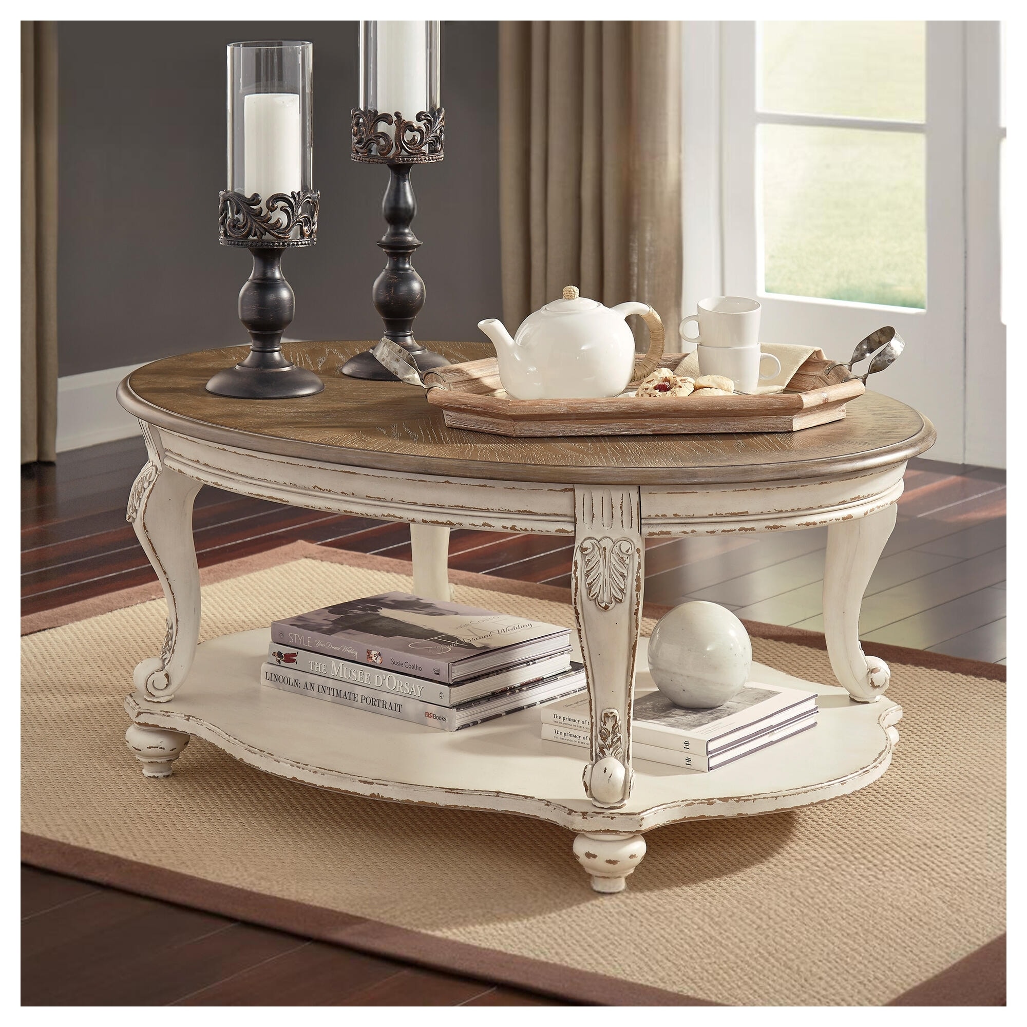 Signature Design by Ashley Realyn Oval Coffee Table with Lower Shelf - 48.13" W x 34" D x 19.88" H
