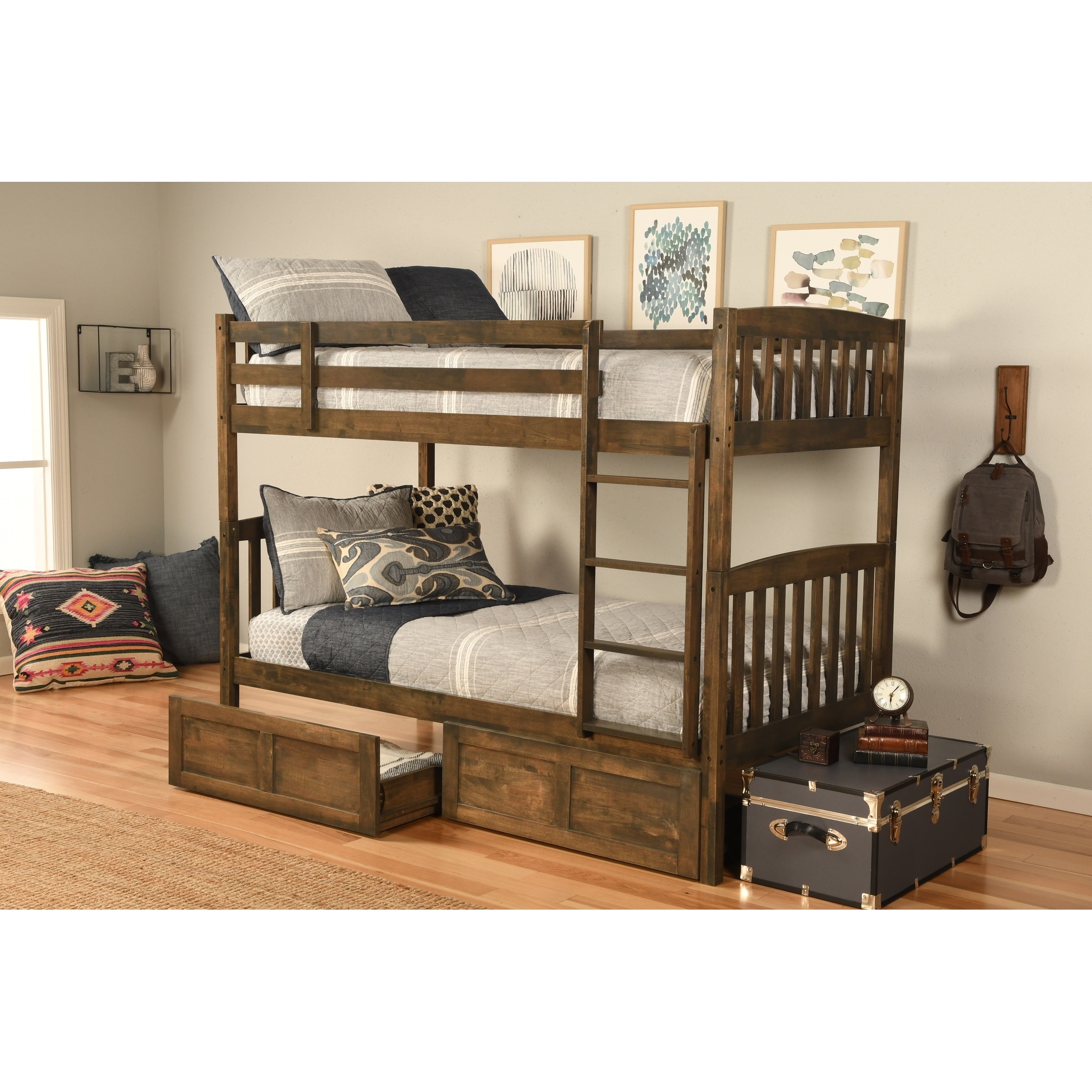 Dark blue wooden bunk bed with two levels, under-bed storage drawers pulled out, in a bedroom with light wood floor and decor items.