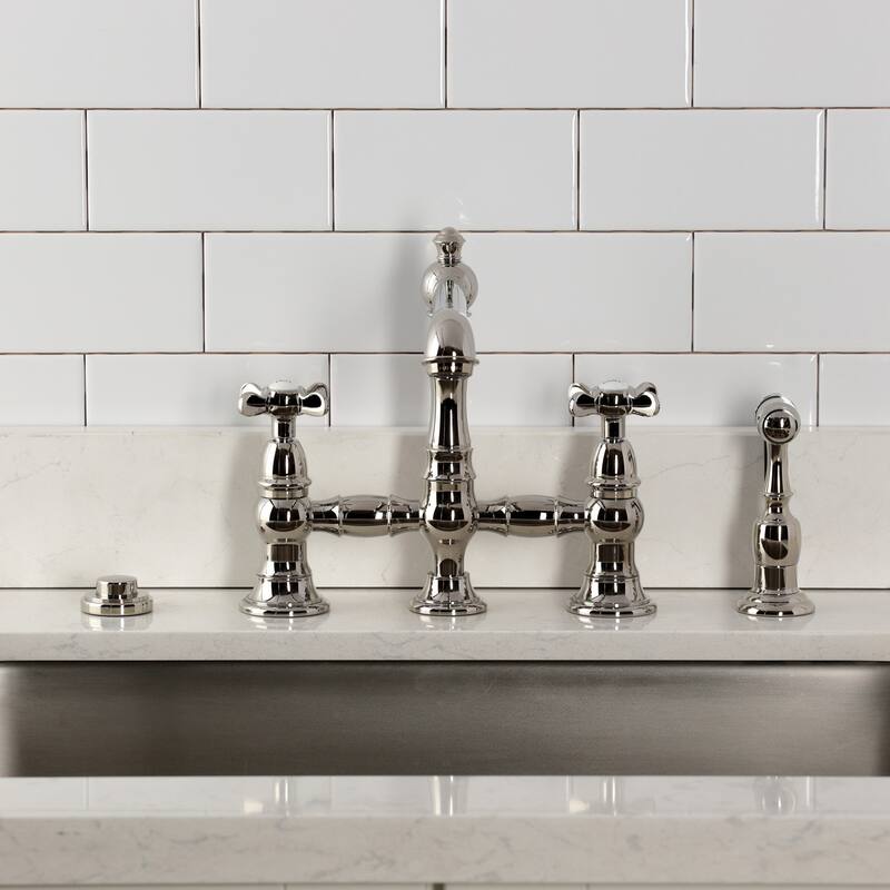 Kingston Brass Essex Two-Handle 4-Hole Deck Mount Bridge Kitchen Faucet with Brass Side Sprayer