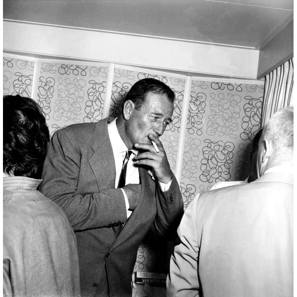 John Wayne smoking at a social event Photo Print - Bed Bath & Beyond