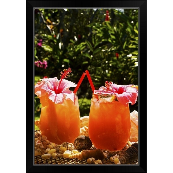 "Two tropical drinks garnished with flowers in an outdoor setting." Black Framed Print
