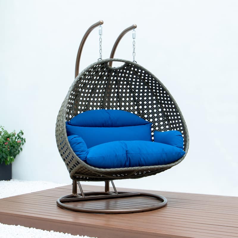 LeisureMod 2-Person Hanging Egg Swing Chair with Metal Stand - Handcrafted Beige Wicker, Patio Hammock Lounger with Cushions