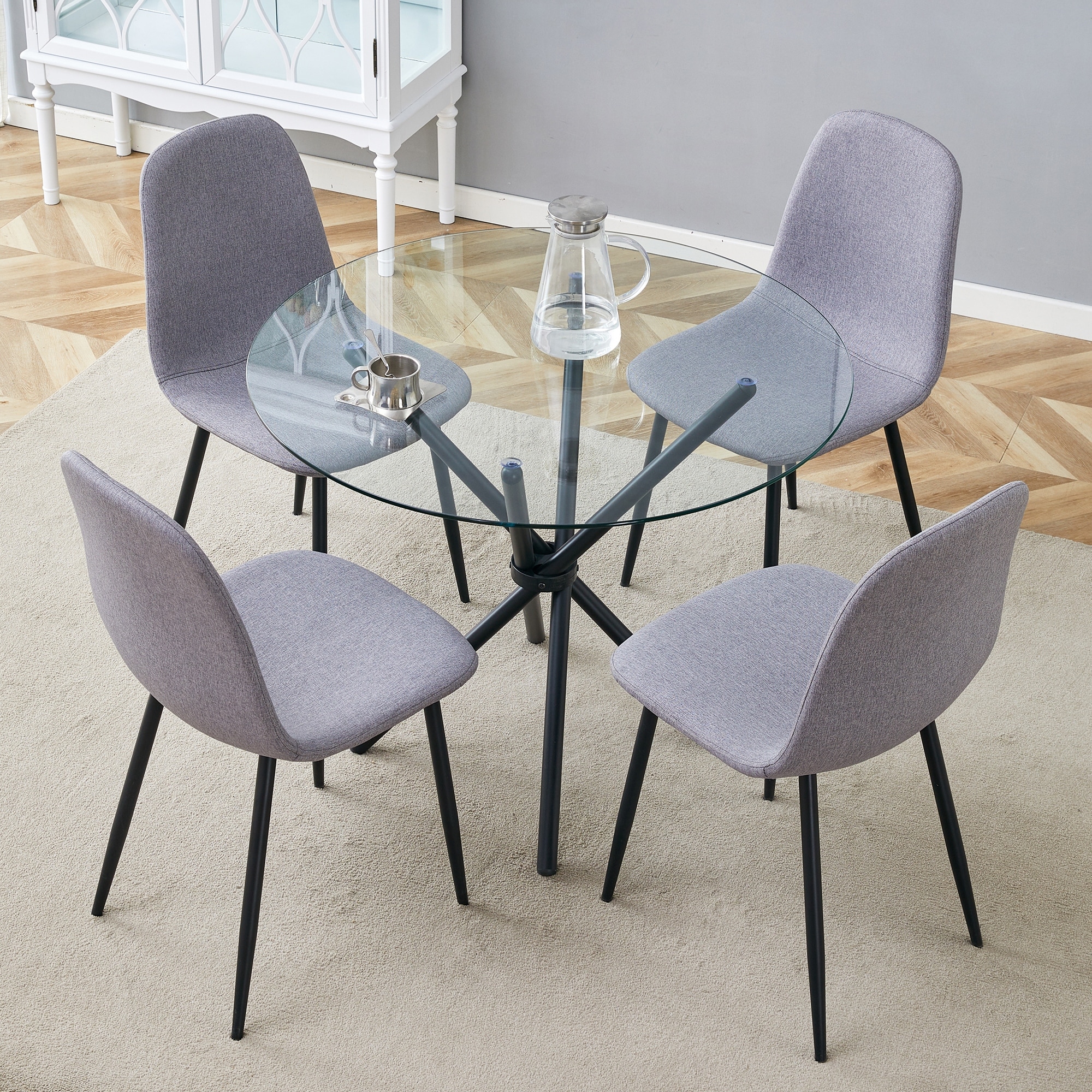 Table and chair set.A Modern Transparent Tempered Glass Round Table With A Diameter Of 36.6 Inches With Black Metal Legs