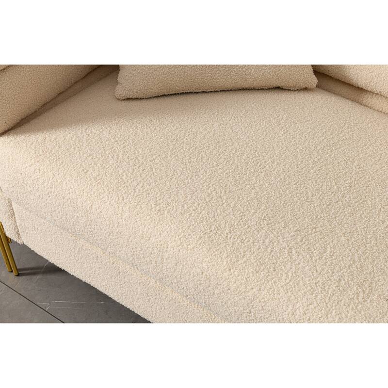 Luxurious and comfortable upholstered sofa with golden legs and pillows for living room and reception area