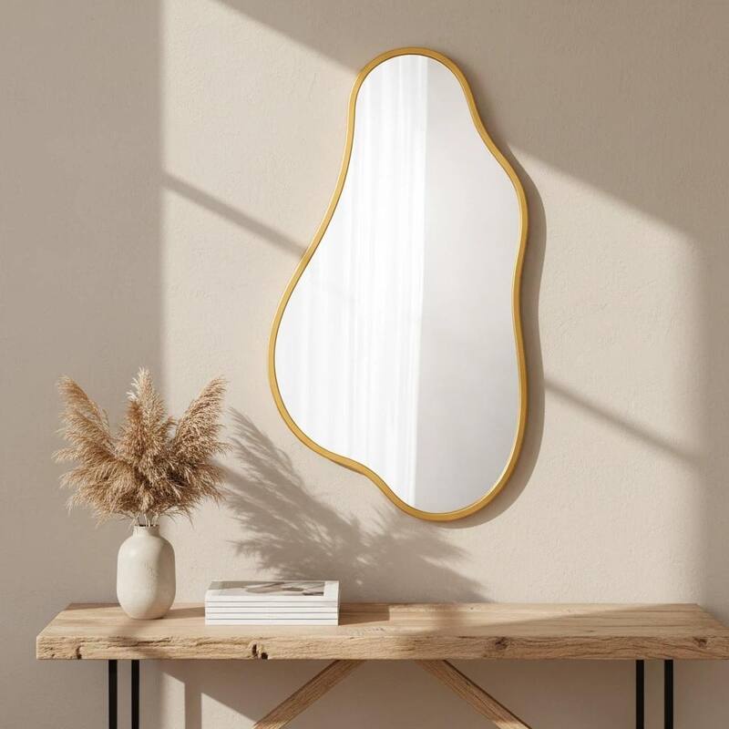 A modern-style, irregularly shaped wall-mounted mirror with a gold frame, suitable for a dressing table or bathroom