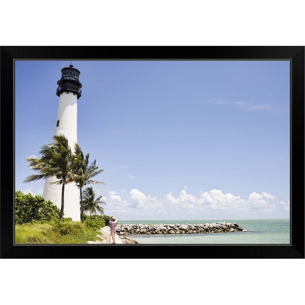 "Lighthouse and tropical palm trees near ocean" Black Framed Print