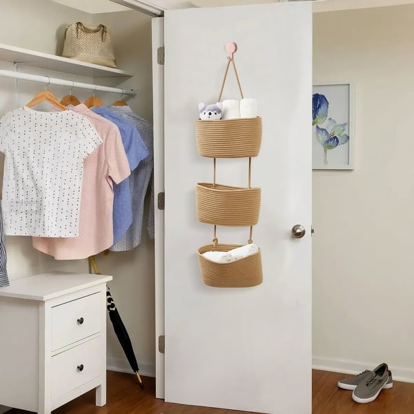 Three tier woven basket organizer hanging on a closet door