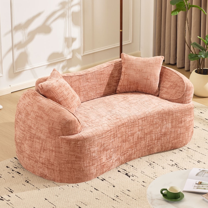 Curved 2 person compress sofa. It has armrests on both sides, comes with two pillows,is suitable for small - sized apartments - Pink
